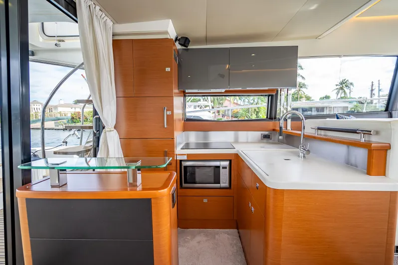 Miss Zoe Yacht Photos Pics Modern kitchen interior on 2014 Prestige 500 Fly yacht, featuring sleek cabinetry and appliances.