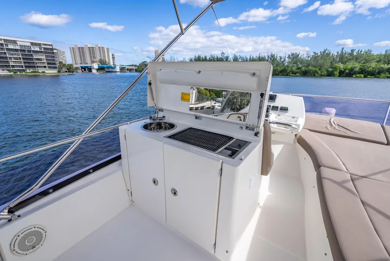Miss Zoe Yacht Photos Pics Prestige 500 Fly 2014 yacht with outdoor kitchenette and scenic water view.