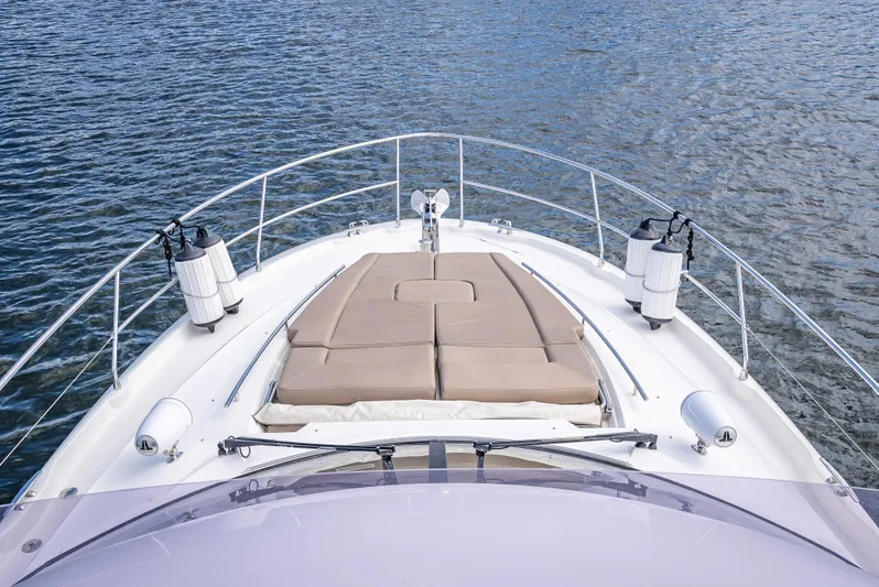 Miss Zoe Yacht Photos Pics Prestige 500 Fly 2014 yacht bow with sunbathing area on calm water.