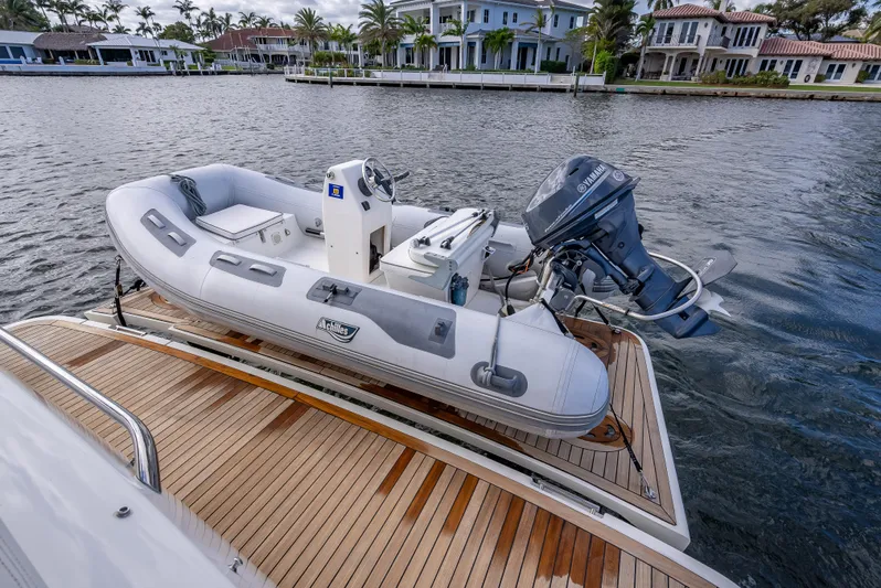 Miss Zoe Yacht Photos Pics Inflatable boat on Prestige 500 Fly yacht, 2014, docked by waterfront homes.