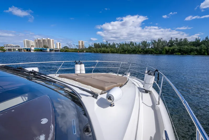 Miss Zoe Yacht Photos Pics Prestige 500 Fly 2014 yacht cruising on a sunny day with cityscape in background.
