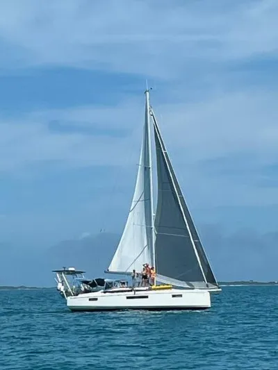Fred's Dream Yacht Photos Pics 2020 Jeanneau Sun Odyssey 410 sailing on open water under clear blue skies.