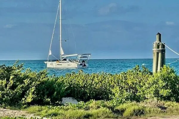 Fred's Dream Yacht Photos Pics Jeanneau Sun Odyssey 410 sailboat anchored in clear blue waters, 2020 model.