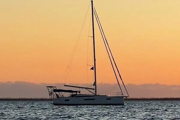 Fred's Dream Yacht Photos Pics 2020 Jeanneau Sun Odyssey 410 sailboat at sunset on calm waters.