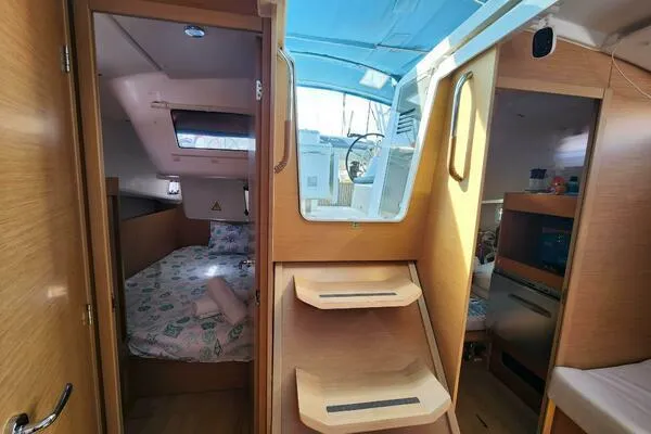 Fred's Dream Yacht Photos Pics Interior of 2020 Jeanneau Sun Odyssey 410 sailboat, featuring cabin, stairs, and skylight.