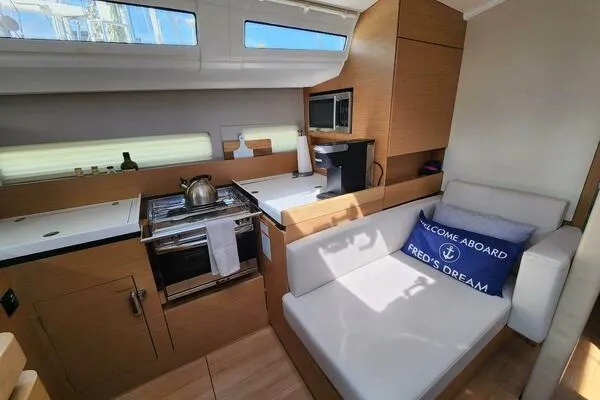 Fred's Dream Yacht Photos Pics Interior of 2020 Jeanneau Sun Odyssey 410 yacht, featuring modern kitchen and cozy seating area.