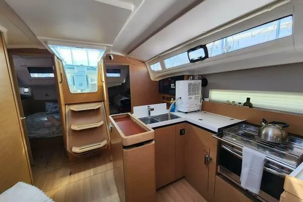 Fred's Dream Yacht Photos Pics Interior of 2020 Jeanneau Sun Odyssey 410 yacht, featuring modern kitchen and cozy cabin space.