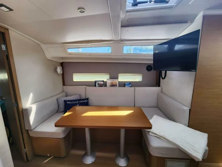 Fred's Dream Yacht Photos Pics Interior of 2020 Jeanneau Sun Odyssey 410 yacht with cozy seating and table.