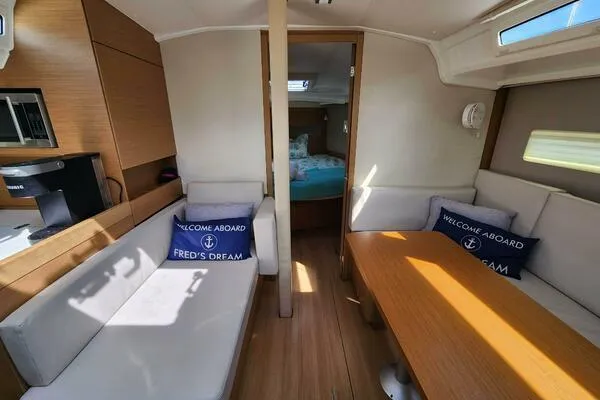 Fred's Dream Yacht Photos Pics Interior of 2020 Jeanneau Sun Odyssey 410 yacht with cozy seating and wooden finishes.