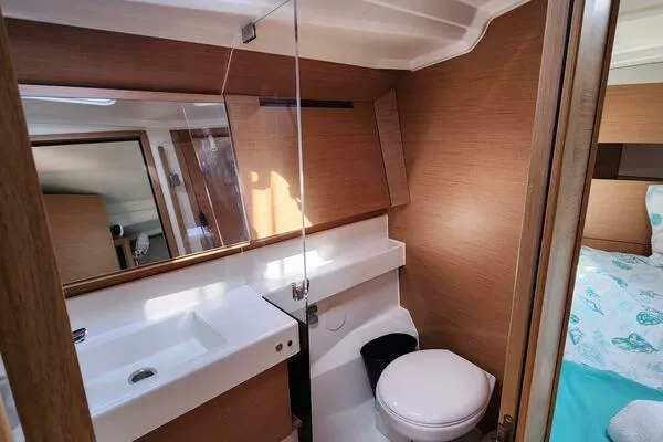 Fred's Dream Yacht Photos Pics 2020 Jeanneau Sun Odyssey 410 bathroom with modern fixtures and wood accents.