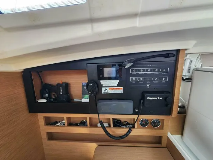 Fred's Dream Yacht Photos Pics Control panel inside 2020 Jeanneau Sun Odyssey 410 yacht, featuring navigation and communication equipment.