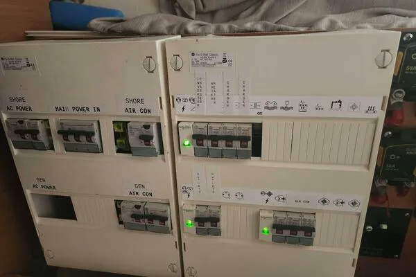 Fred's Dream Yacht Photos Pics Electrical panel on a 2020 Jeanneau Sun Odyssey 410 yacht, showing circuit breakers and controls.