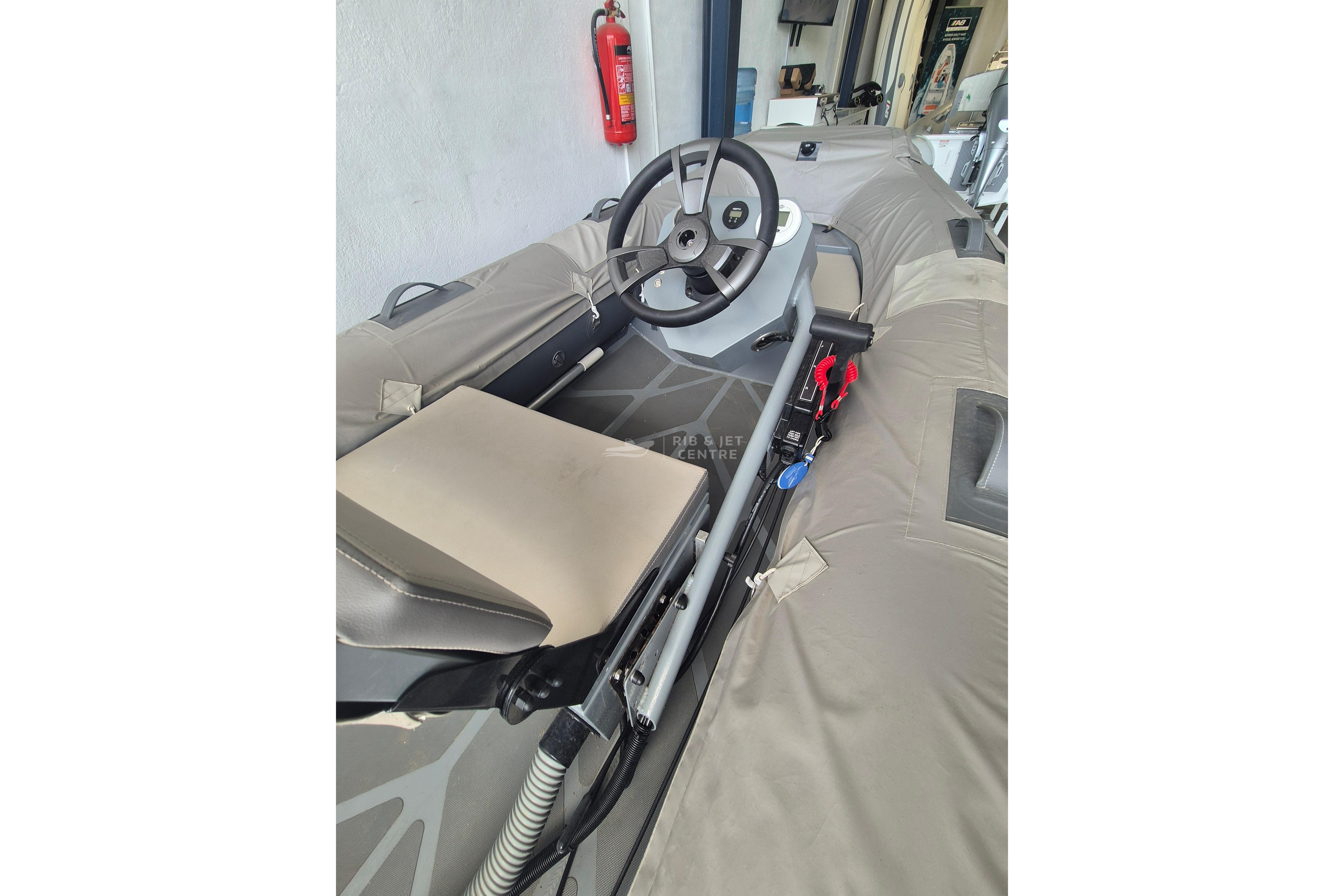 2024 Zur Mini Rib 13 boat interior with steering wheel and seating.