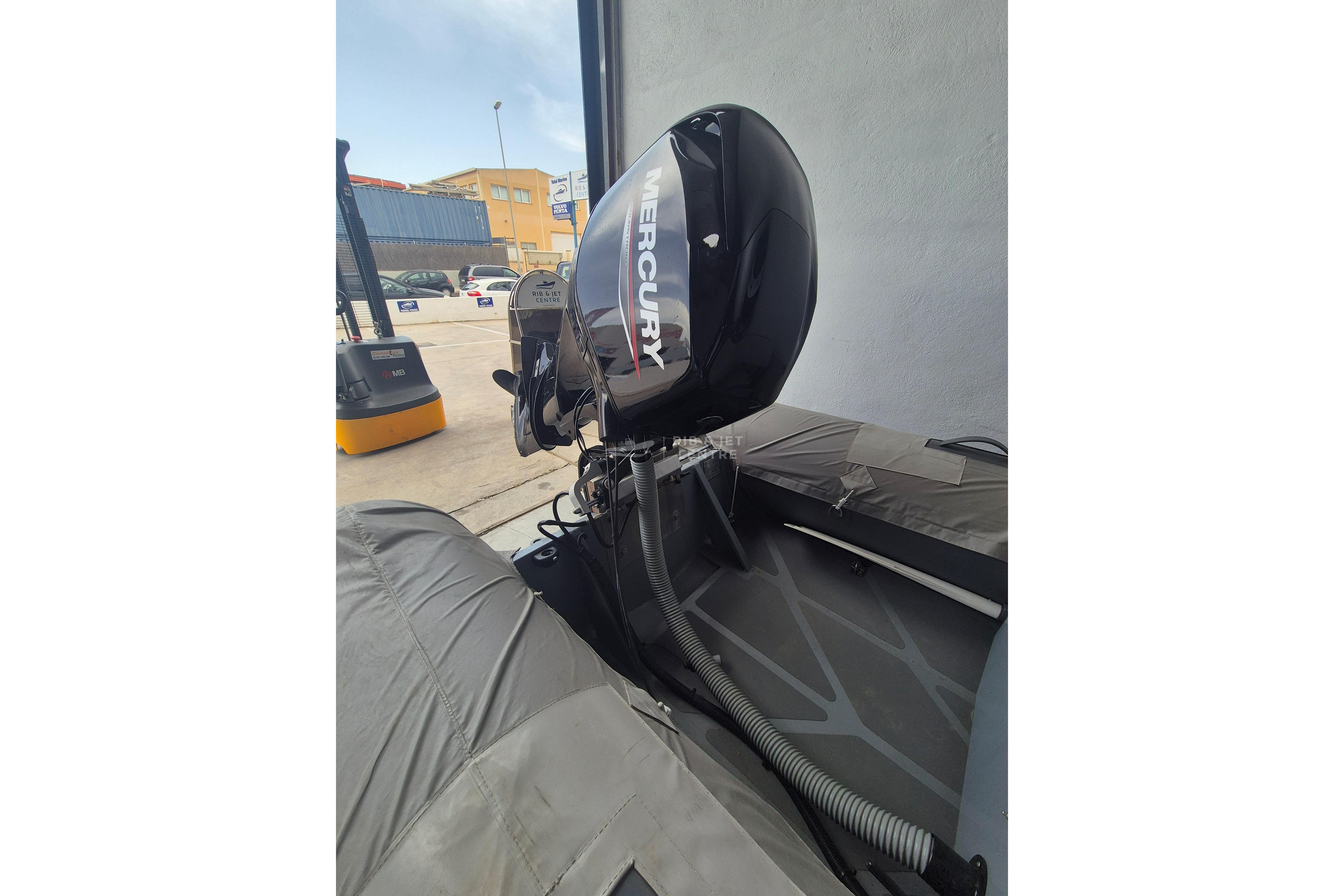 2024 Zur Mini Rib 13 with Mercury outboard motor in a parking area.