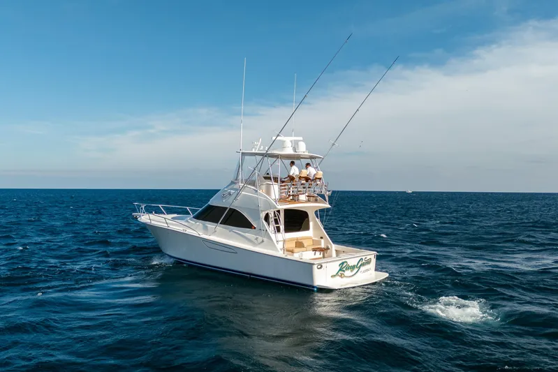 Ring Game Yacht Photos Pics 2008 Viking 42 Convertible yacht cruising on open sea under clear blue sky.