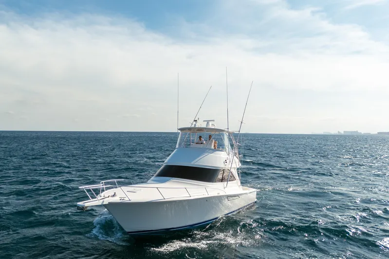 Ring Game Yacht Photos Pics 2008 Viking 42 Convertible yacht cruising on open sea under clear sky.