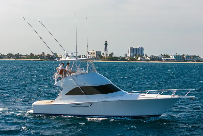 Ring Game Yacht Photos Pics 2008 Viking 42 Convertible yacht cruising near coastal cityscape.