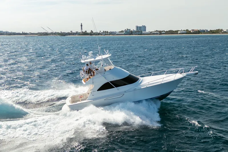 Ring Game Yacht Photos Pics 2008 Viking 42 Convertible yacht cruising on open water near coastline.