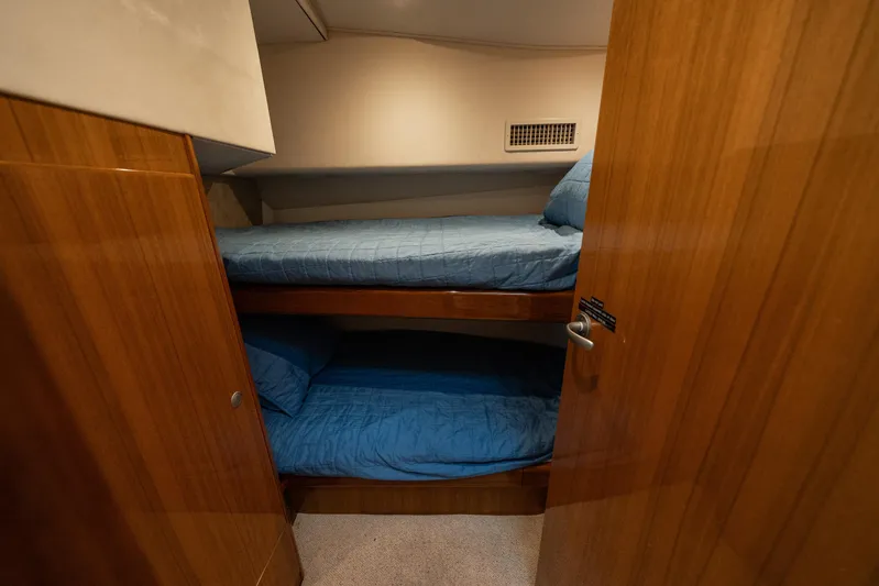 Ring Game Yacht Photos Pics 2008 Viking 42 Convertible yacht cabin with wooden interior and bunk beds.