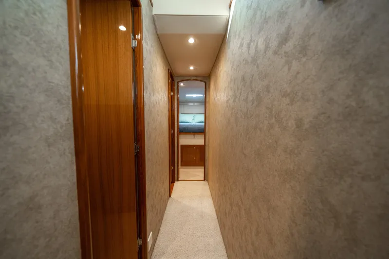 Ring Game Yacht Photos Pics Hallway inside 2008 Viking 42 Convertible yacht, featuring wooden doors and soft lighting.