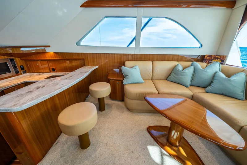 Ring Game Yacht Photos Pics Luxurious interior of 2008 Viking 42 Convertible yacht with plush seating and elegant wood finishes.