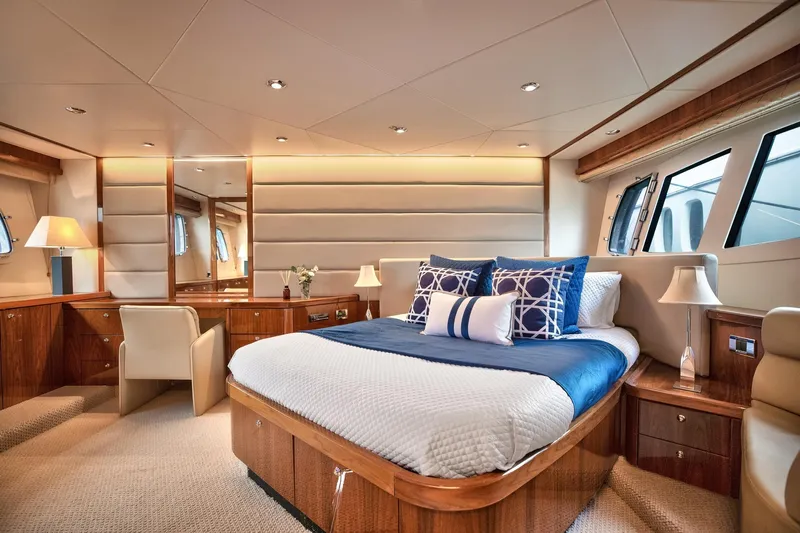 Azzurro Yacht Photos Pics Luxurious bedroom interior of 2009 Sunseeker Manhattan 70 yacht with elegant wood finishes.