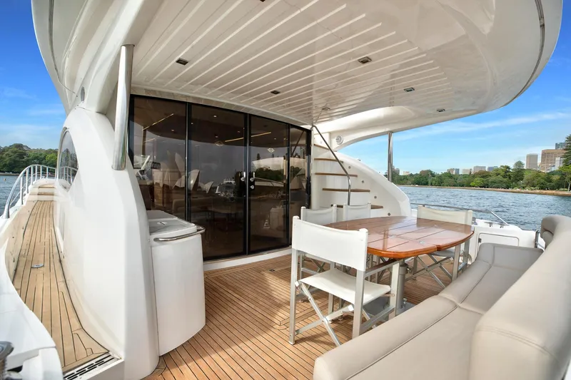 Azzurro Yacht Photos Pics Luxurious 2009 Sunseeker Manhattan 70 yacht with elegant outdoor seating and scenic water views.