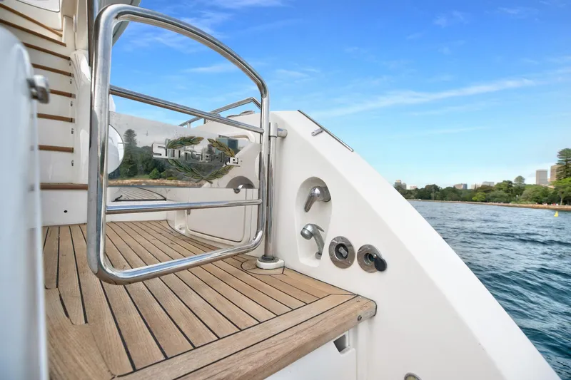 Azzurro Yacht Photos Pics Sunseeker Manhattan 70 yacht deck, 2009 model, with ocean view and clear blue sky.