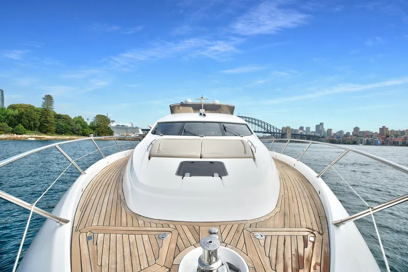 Azzurro Yacht Photos Pics 2009 Sunseeker Manhattan 70 yacht cruising near city skyline and bridge.