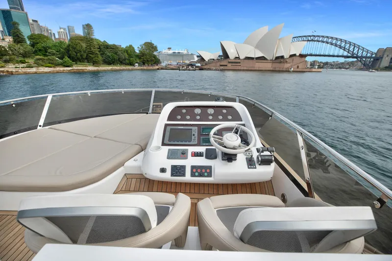 Azzurro Yacht Photos Pics Sunseeker Manhattan 70 yacht helm with Sydney Opera House and Harbour Bridge in background.