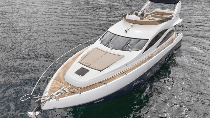 Azzurro Yacht Photos Pics 2009 Sunseeker Manhattan 70 yacht on water, showcasing sleek design and luxury features.