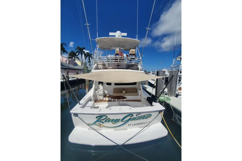 Ring Game Yacht Photos Pics 2015 Viking 42 Convertible yacht docked, featuring a shaded deck and sleek design.