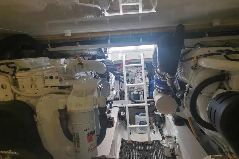 Ring Game Yacht Photos Pics Engine room of a 2015 Viking 42 Convertible yacht, showcasing machinery and equipment.