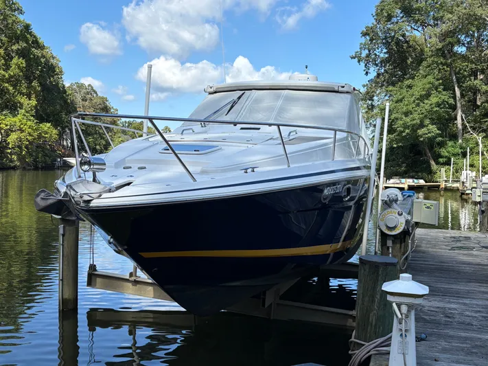 Wining Down Yacht Photos Pics 2016 Regal 35 Sport Coupe docked on a sunny day, surrounded by lush greenery.