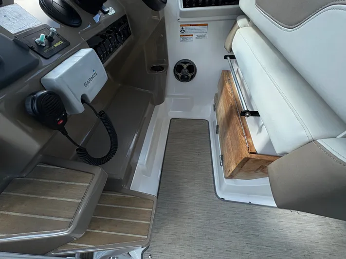 Wining Down Yacht Photos Pics 2016 Regal 35 Sport Coupe helm with Garmin device and cushioned seating.