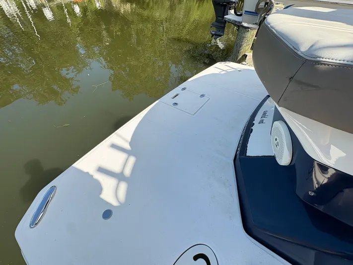 Wining Down Yacht Photos Pics 2016 Regal 35 Sport Coupe boat deck near calm water.