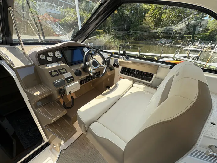 Wining Down Yacht Photos Pics 2016 Regal 35 Sport Coupe helm with modern controls and comfortable seating.