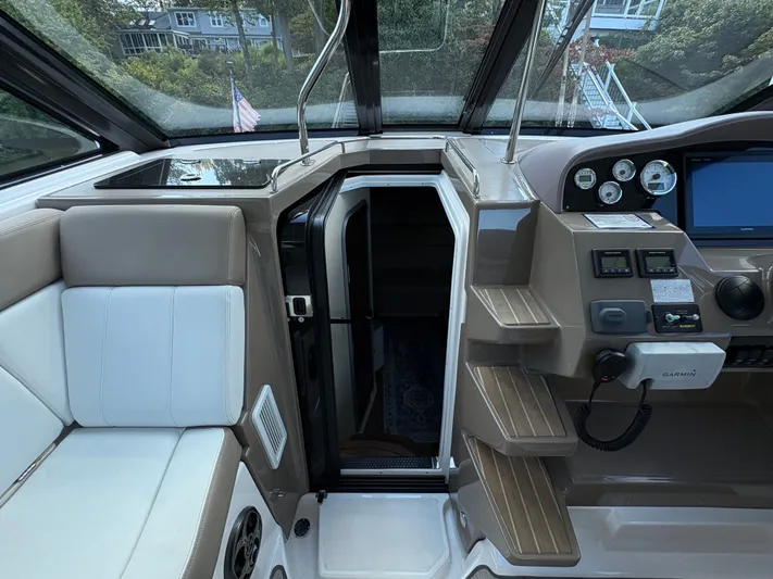 Wining Down Yacht Photos Pics Interior view of a 2016 Regal 35 Sport Coupe boat cockpit with seating and control panel.