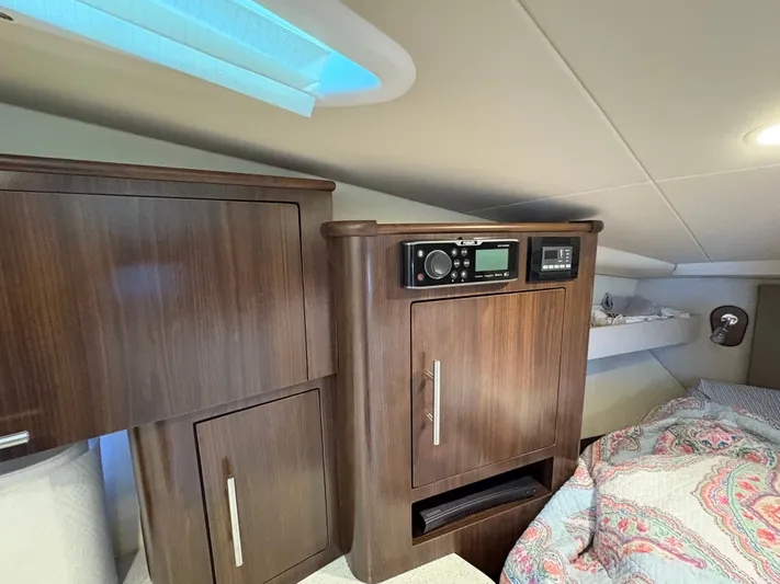 Wining Down Yacht Photos Pics Interior of 2016 Regal 35 Sport Coupe with wood cabinetry and bedding.