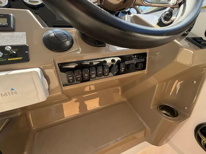 Wining Down Yacht Photos Pics 2016 Regal 35 Sport Coupe dashboard with steering wheel and control panel.