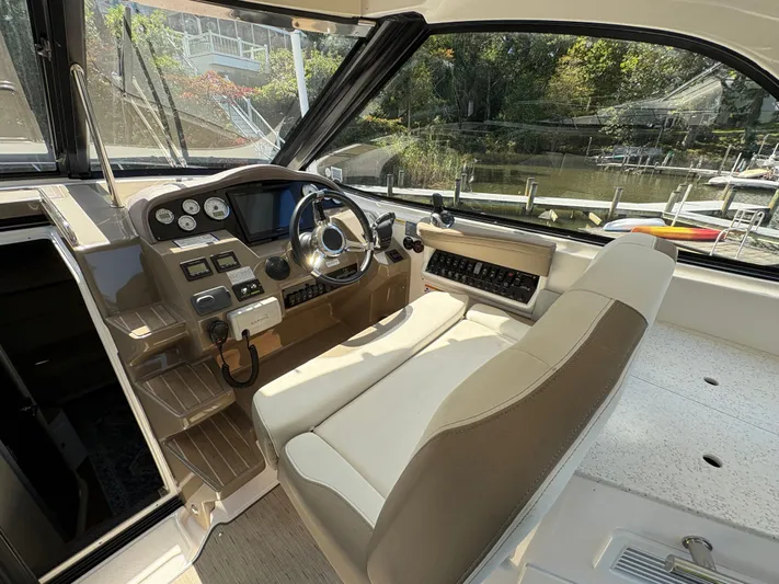 Wining Down Yacht Photos Pics 2016 Regal 35 Sport Coupe helm with modern controls and comfortable seating.