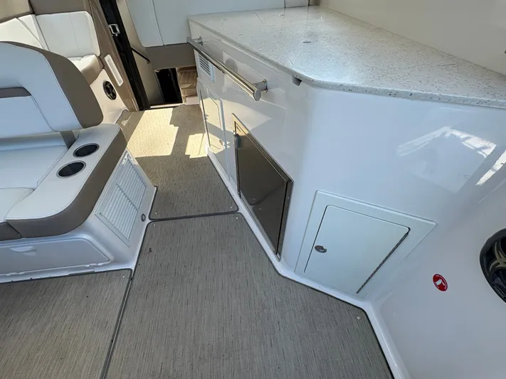 Wining Down Yacht Photos Pics Interior of 2016 Regal 35 Sport Coupe with seating and kitchenette area.