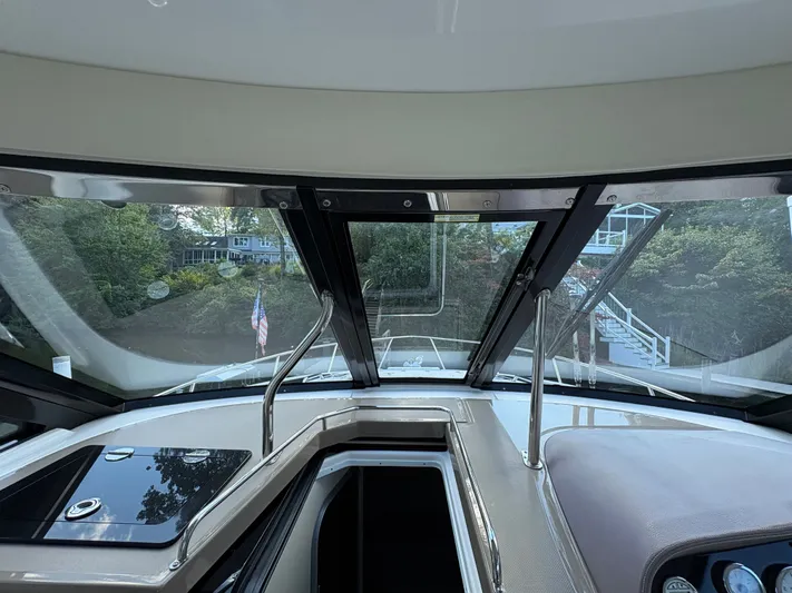 Wining Down Yacht Photos Pics Interior view of 2016 Regal 35 Sport Coupe yacht cockpit with scenic background.