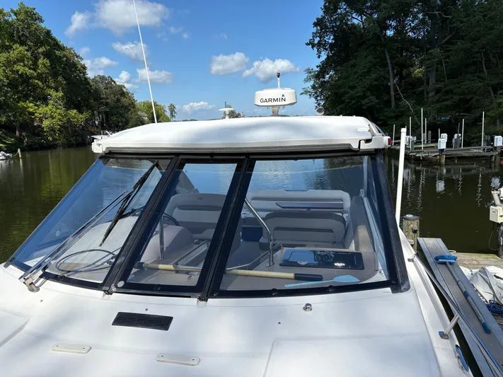Wining Down Yacht Photos Pics 2016 Regal 35 Sport Coupe docked by a serene river under a clear blue sky.