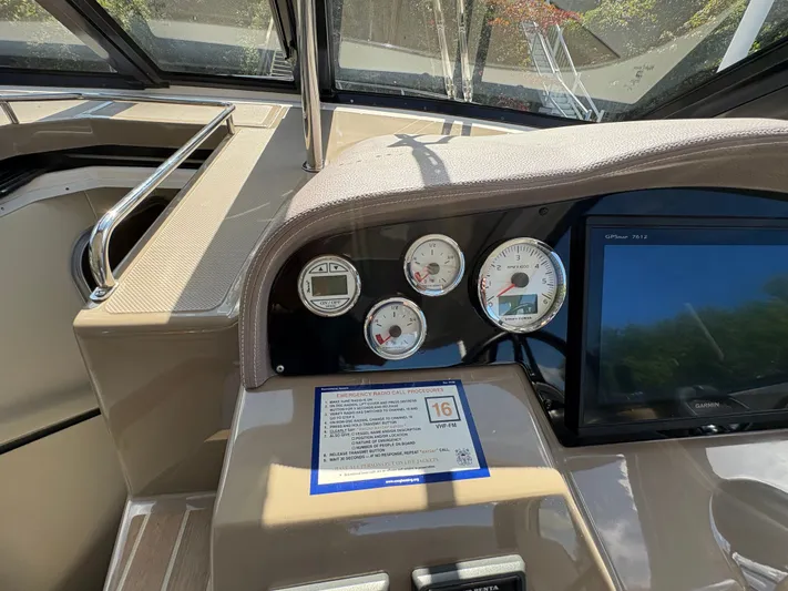 Wining Down Yacht Photos Pics Dashboard of a 2016 Regal 35 Sport Coupe with gauges and Garmin display.