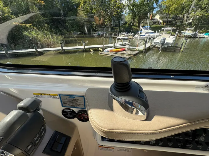 Wining Down Yacht Photos Pics Interior view of a 2016 Regal 35 Sport Coupe, showcasing the control panel and joystick.
