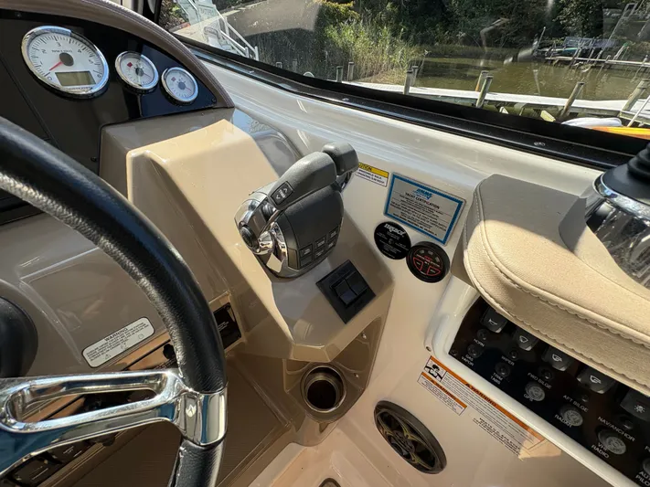 Wining Down Yacht Photos Pics Control panel of a 2016 Regal 35 Sport Coupe boat with steering wheel and throttle.