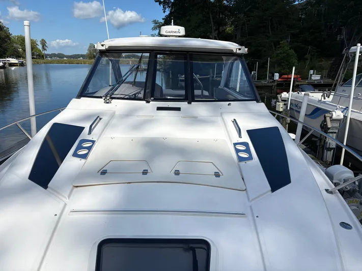 Wining Down Yacht Photos Pics 2016 Regal 35 Sport Coupe yacht docked by a serene lake.