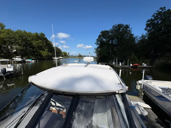 Wining Down Yacht Photos Pics 2016 Regal 35 Sport Coupe docked on a serene river with lush greenery.