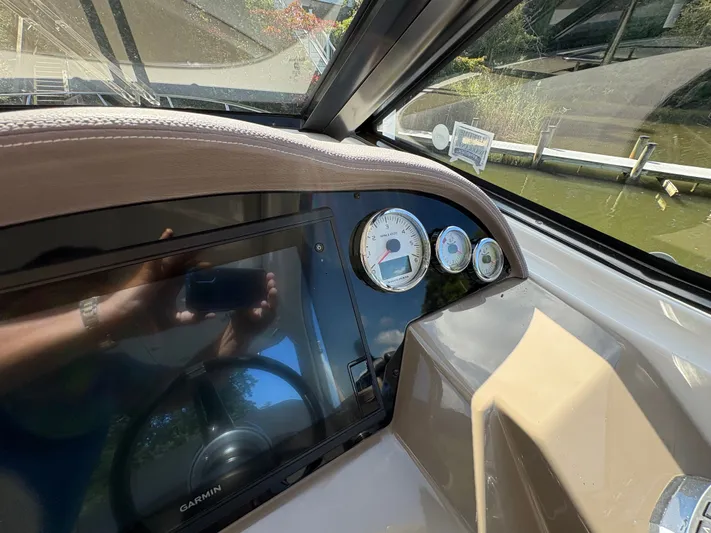 Wining Down Yacht Photos Pics Dashboard of a 2016 Regal 35 Sport Coupe with gauges and Garmin display.